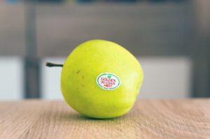 A produce sticker on an apple