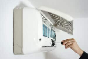person fixing AC-- air conditioning maintenance Salt Lake City
