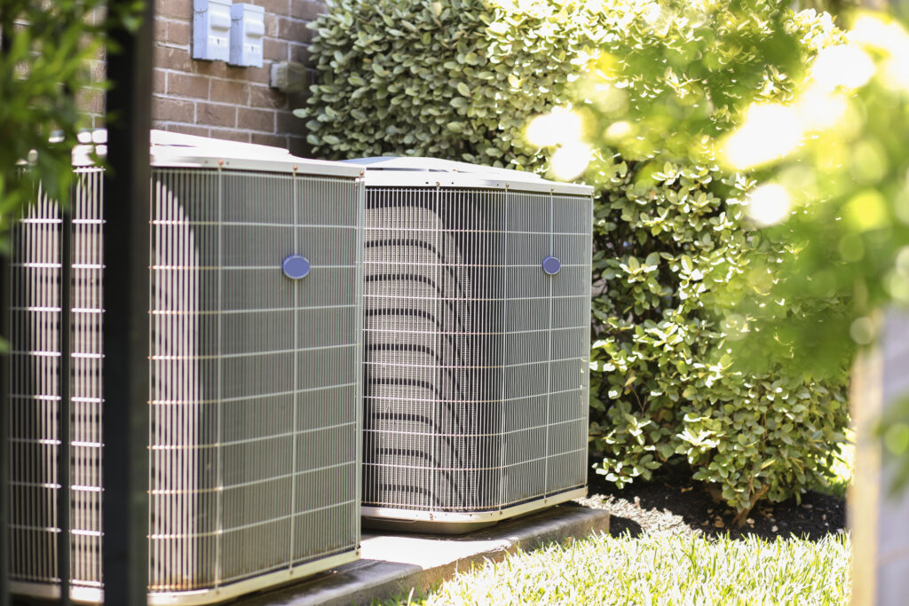 Two HVAC units outside a home.